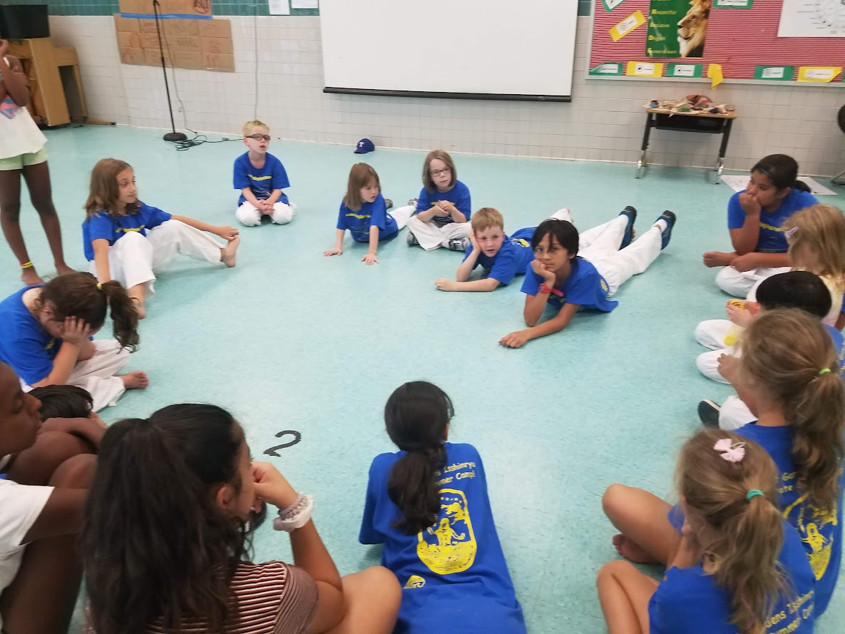 Kids in camp circle activity indoors
