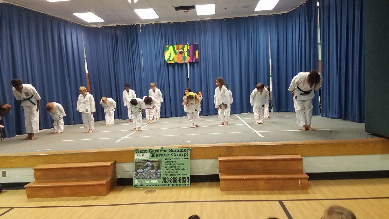 Kids bowing on stage karate