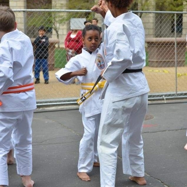 Young student yellow belt punch