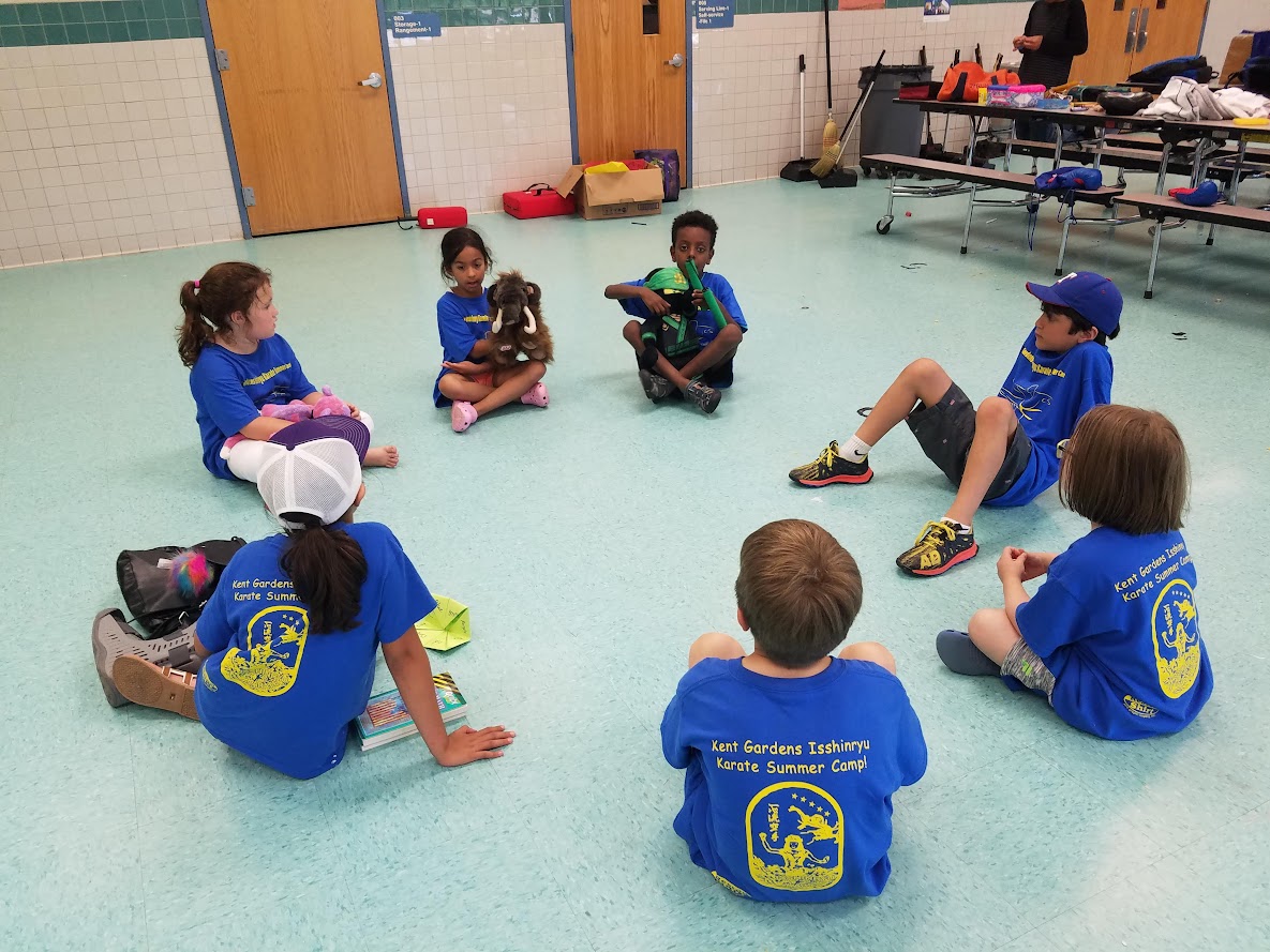 Kids in blue camp shirts circle time
