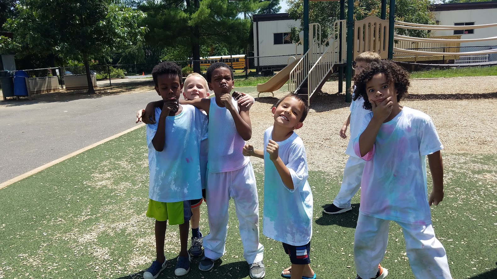 Tie-dye kids posing at playground
