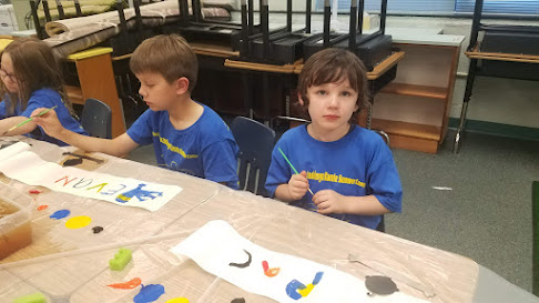 Two kids painting at table