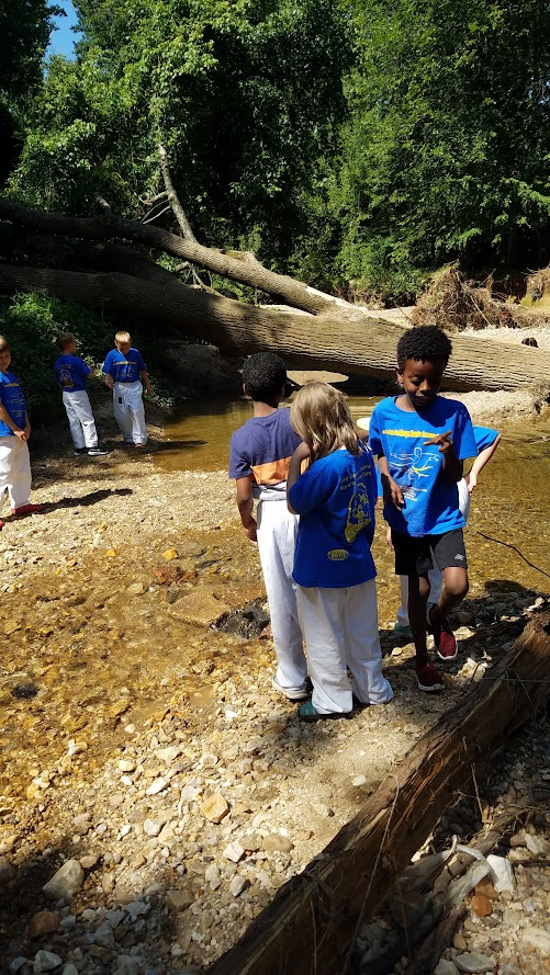 Campers exploring creek and rocks