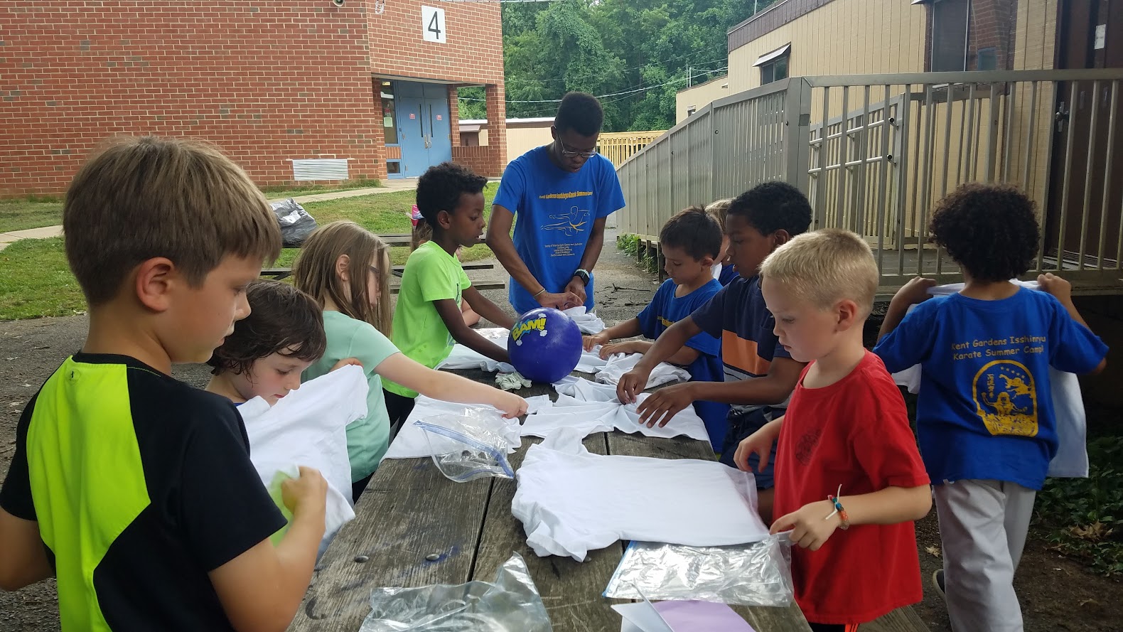 Kids preparing white shirts for tie-dye