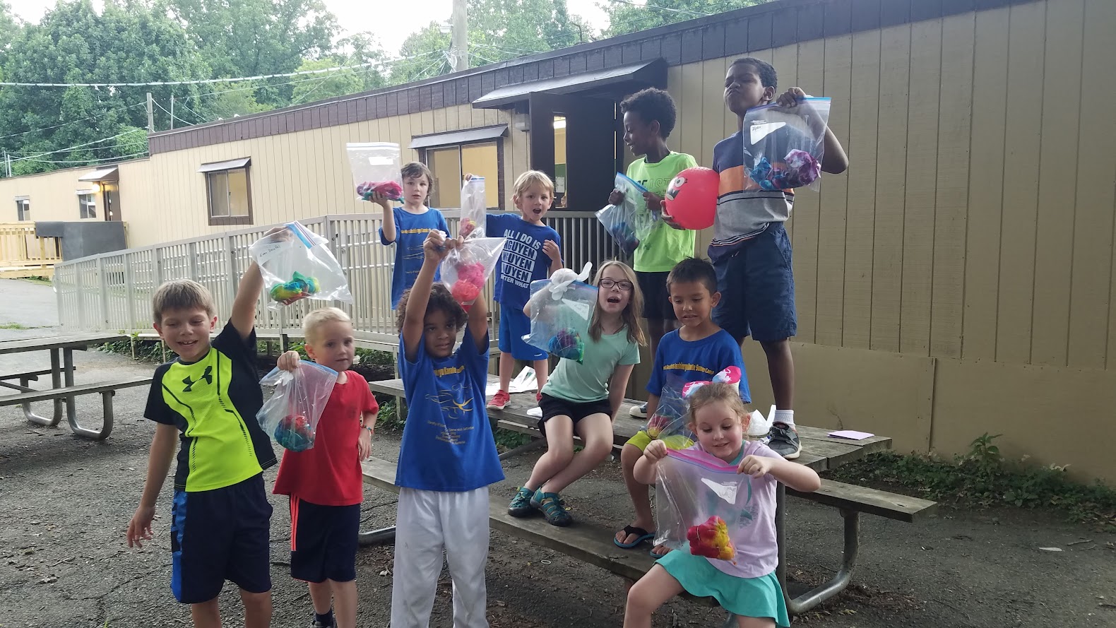 Excited group showing tie-dye bags