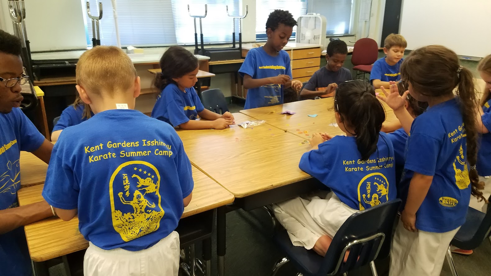 Camp shirt kids doing crafts at table
