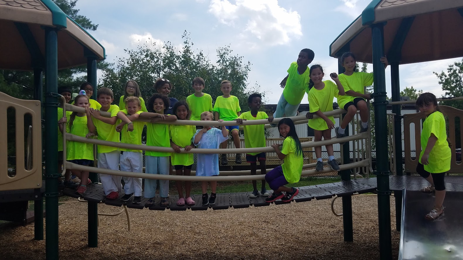 Group smiling on playground structure